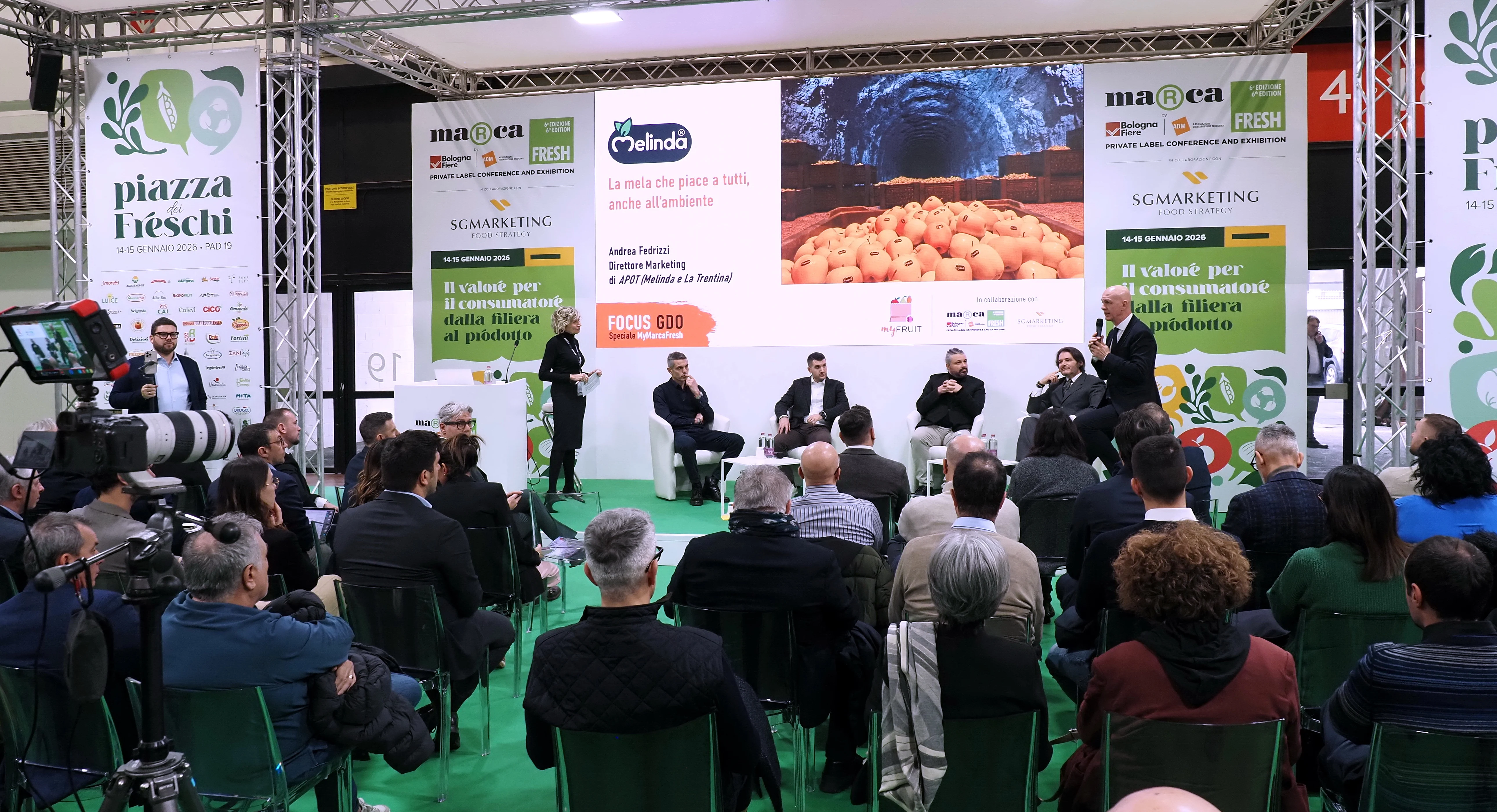 A Marca Fresh professional session with a seated audience, speakers and fresh-produce programme graphics inside BolognaFiere.