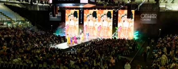 A live professional hair show presented to a large Cosmoprof audience.