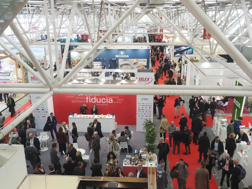 Visitors move through a retailer exhibition area at MARCA 2026, with products arranged across the stand below.