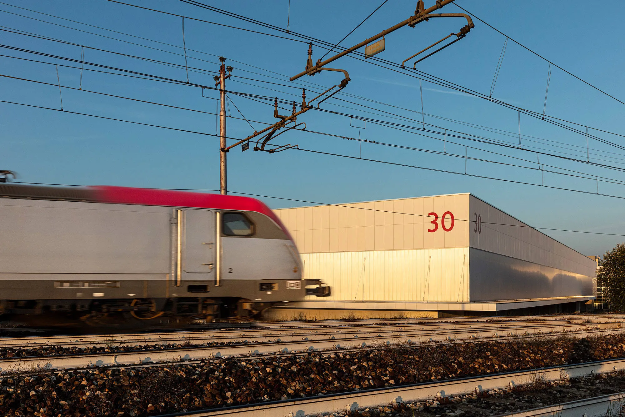A train passing BolognaFiere Pavilion 30 in Bologna.