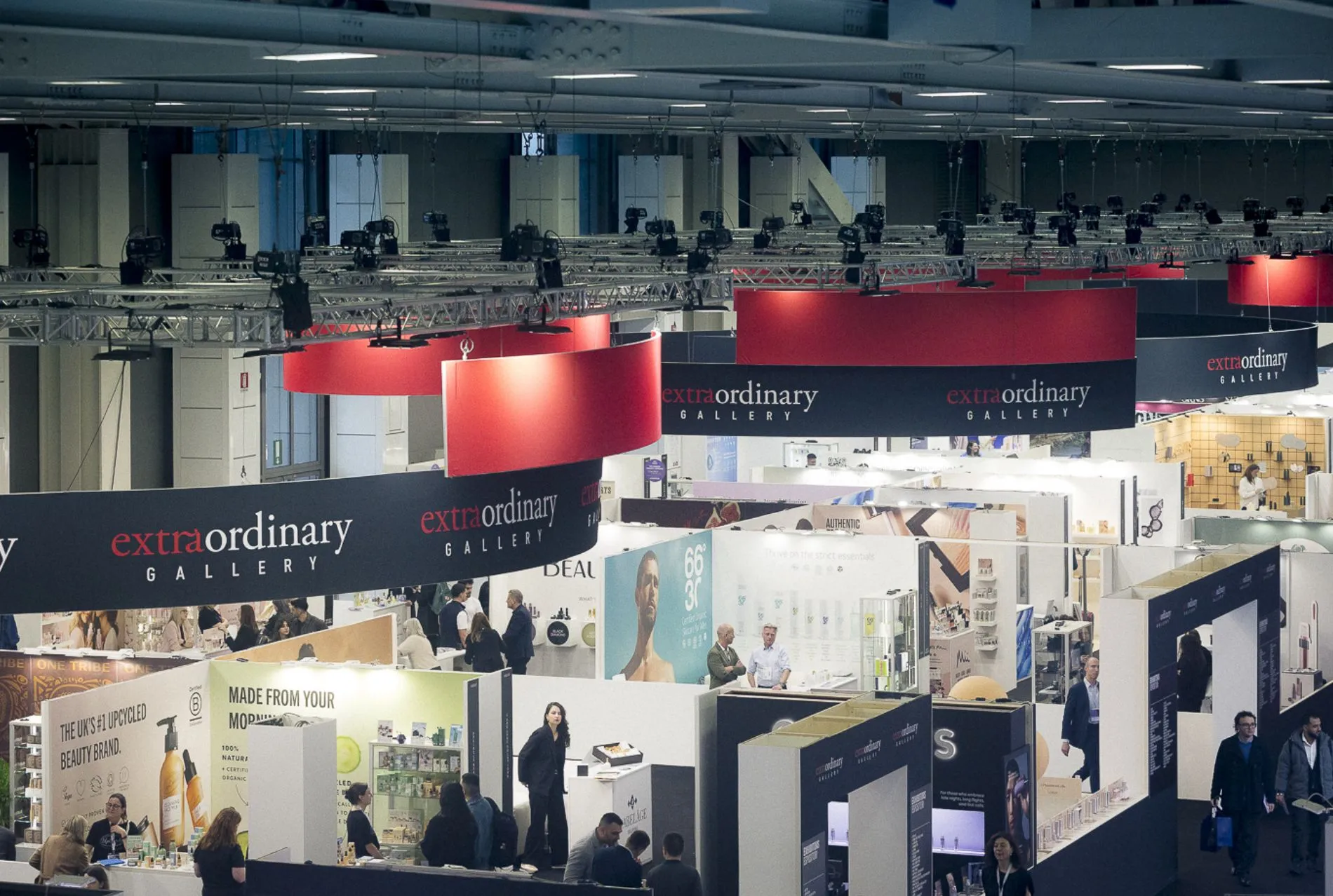 A wide view of exhibitors and visitors across the Cosmoprof show floor in Bologna.