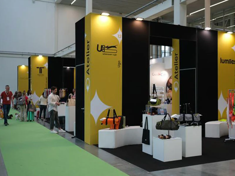 The premium Atelier area at Zoomark 2025 with brand displays and trade visitors moving through the aisle.